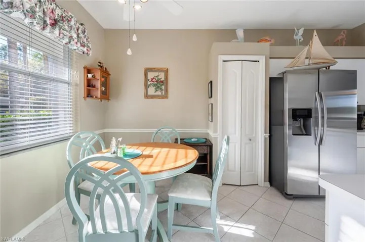Dining area featuring light tile patterned floors, baseboards, and ceiling fan