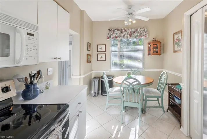 Dining area featuring ceiling fan and light tile patterned flooring