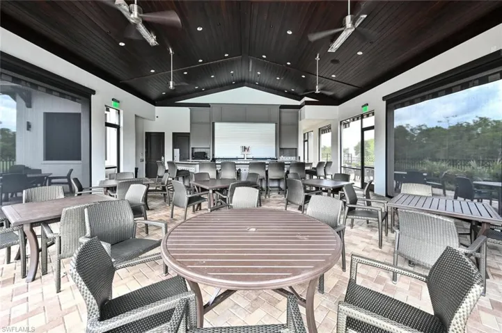 View of patio / terrace with exterior kitchen, outdoor dining area, and ceiling fan