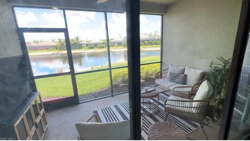 Sunroom / solarium with a water view