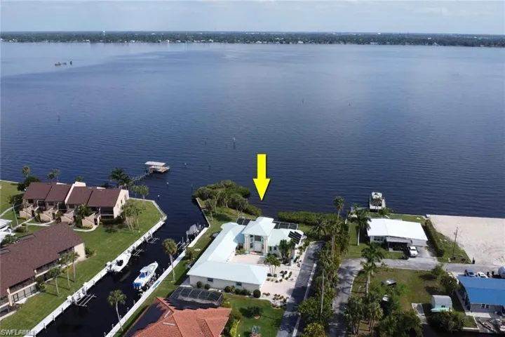 Birds eye view of property featuring a water view and a residential view