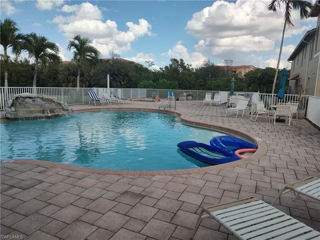 Community pool with a patio