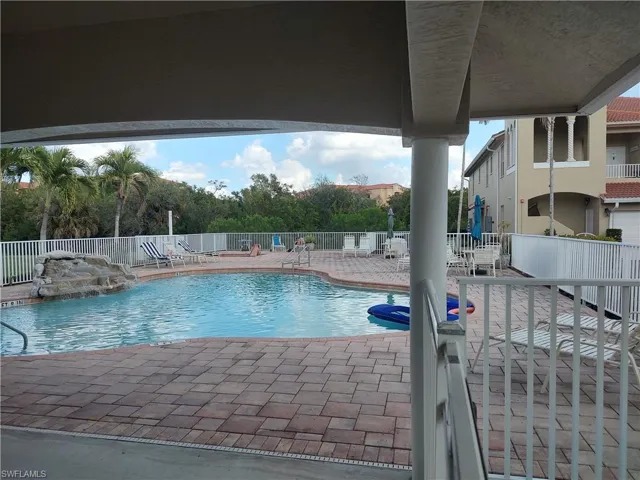 Community pool featuring a patio