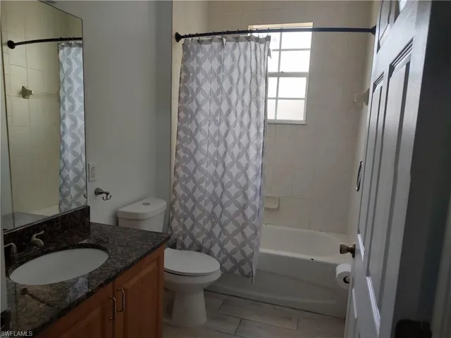 Full bath featuring vanity and shower / tub combo