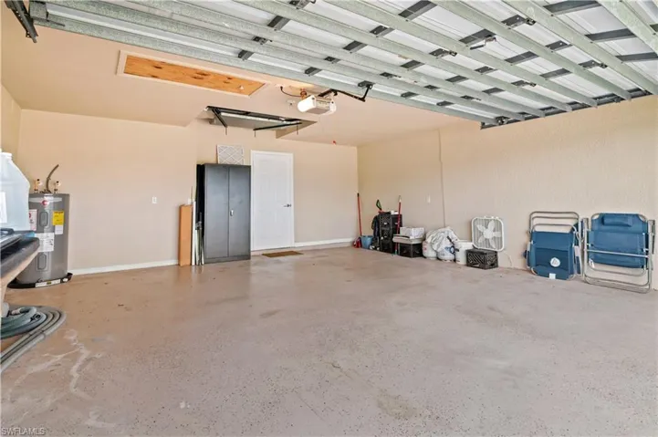 Garage with electric water heater and a garage door opener
