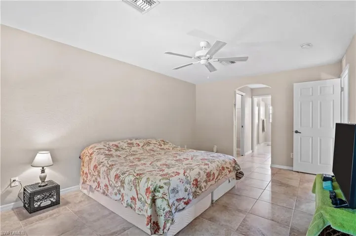 Tiled bedroom with ceiling fan