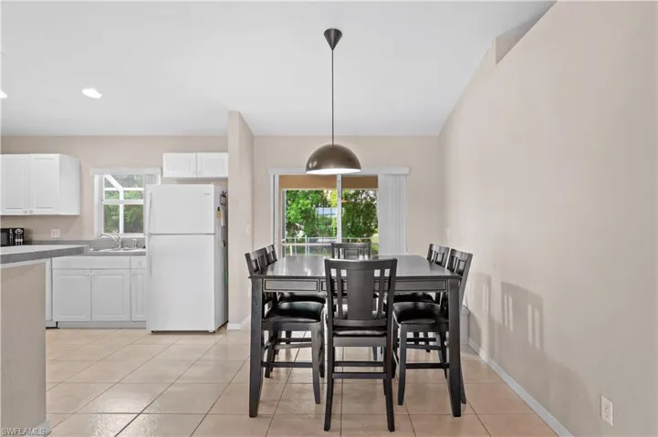 Tiled dining area featuring sink
