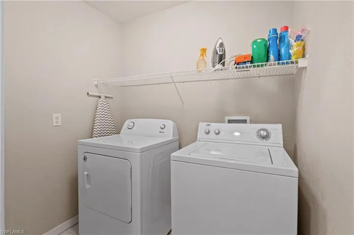 Clothes washing area featuring washing machine and clothes dryer