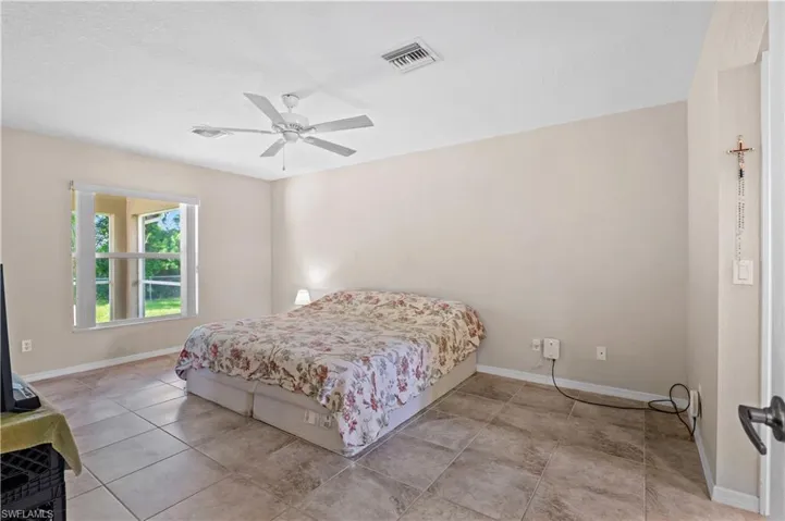 Tiled bedroom with ceiling fan