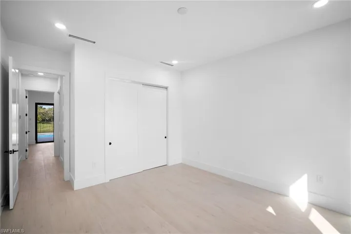 Unfurnished bedroom featuring light wood-type flooring and a closet