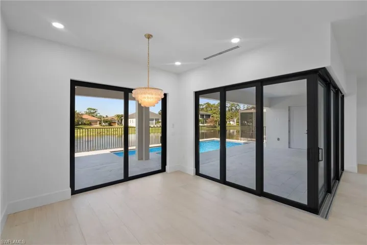 Spare room featuring light hardwood / wood-style flooring and a notable chandelier