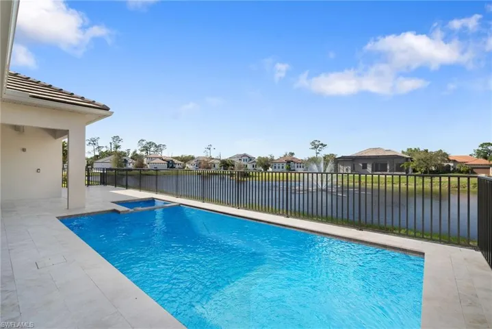View of pool featuring a patio area and a water view
