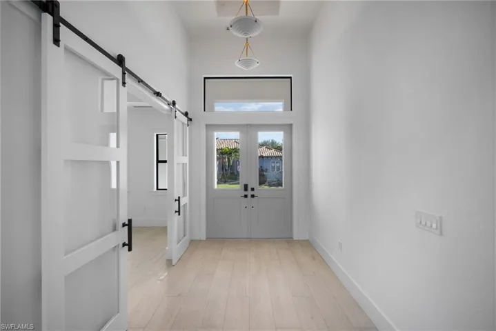 Doorway to outside with french doors and light wood-type flooring