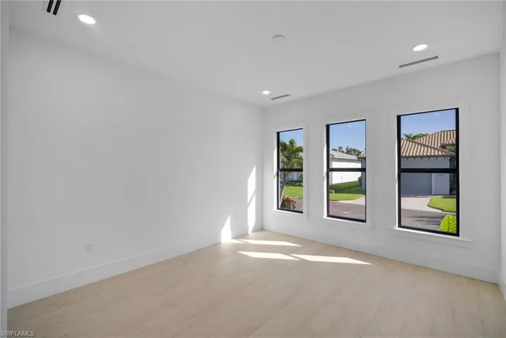 Empty room with light hardwood / wood-style floors