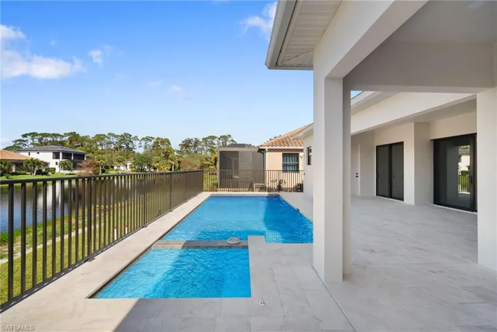 View of swimming pool with a patio area and a water view