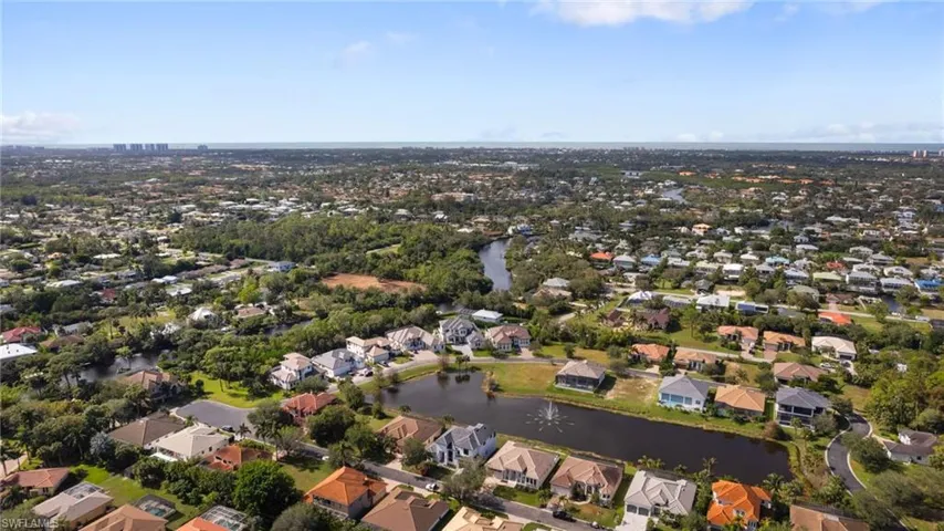 Birds eye view of property with a water view