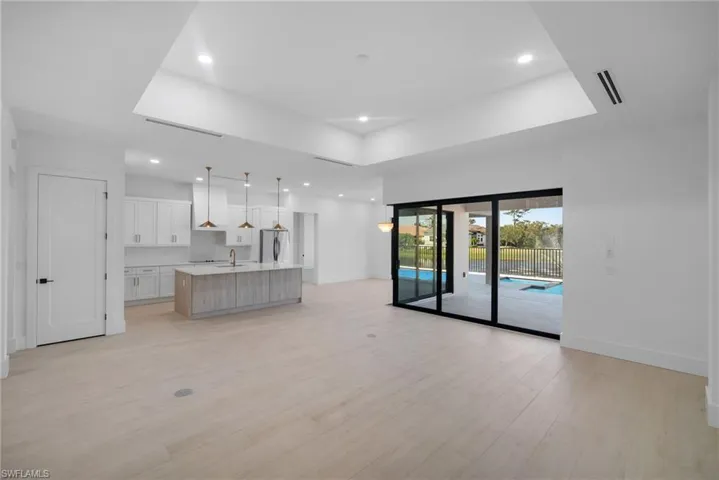 Unfurnished living room featuring light hardwood / wood-style flooring and sink