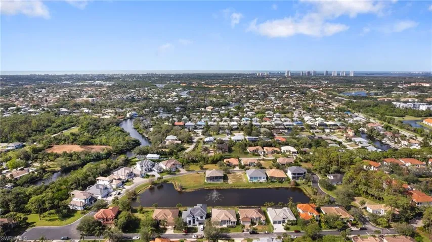 Birds eye view of property with a water view