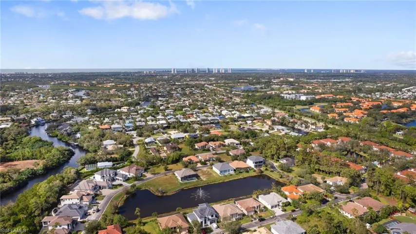 Birds eye view of property with a water view