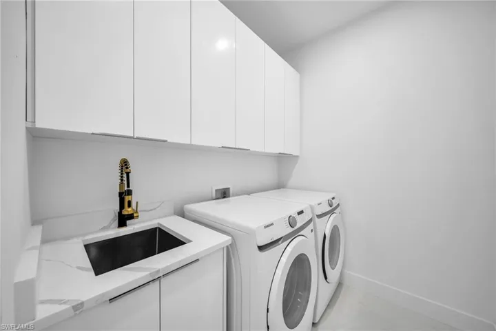 Laundry area with washing machine and clothes dryer and cabinet space