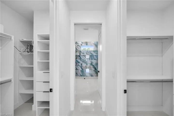 Walk in closet with light tile patterned floors