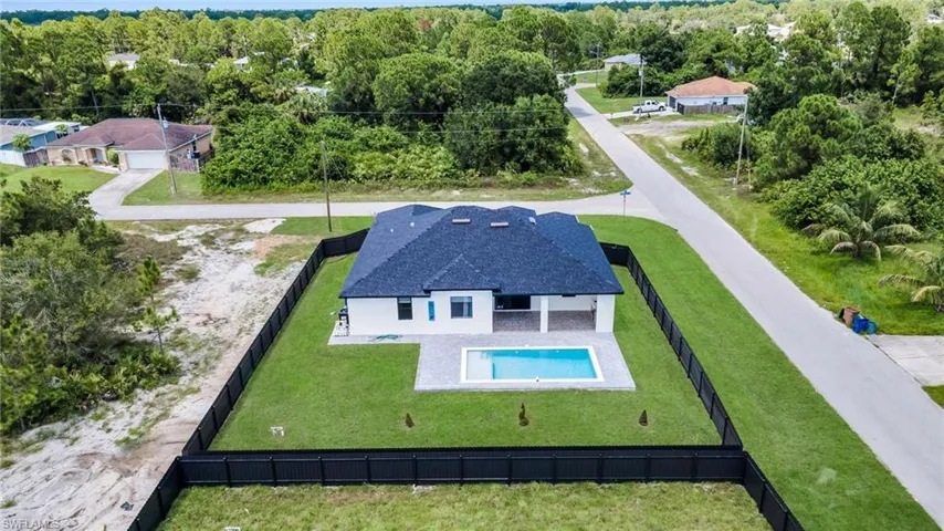 Aerial view of property and surrounding area featuring a pool