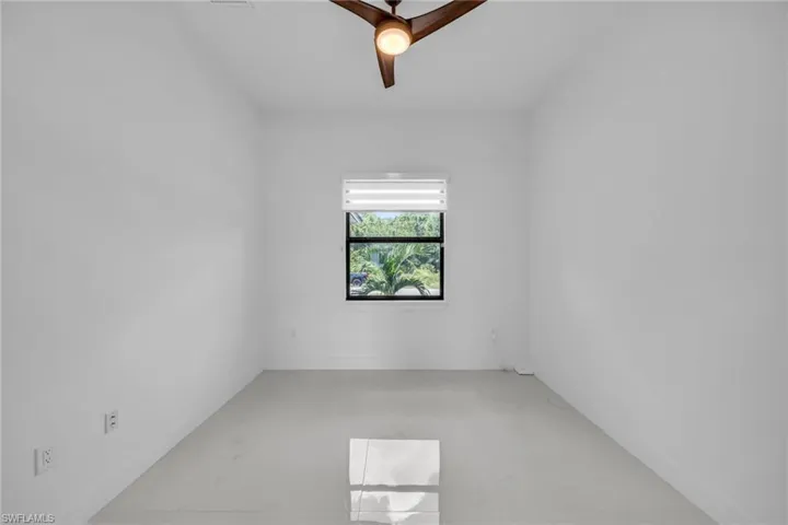 Unfurnished room featuring a ceiling fan