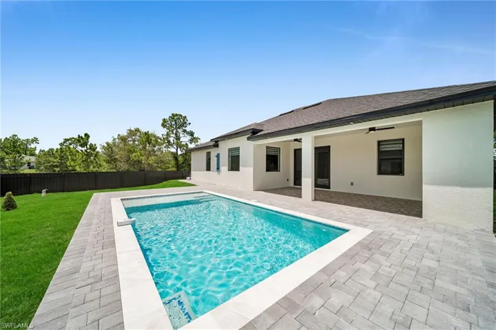 View of pool with a patio area and a ceiling fan