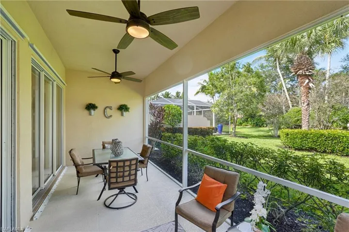 Sunroom / solarium with ceiling fan and outdoor dining area