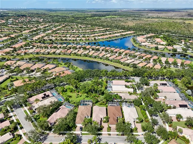 Aerial perspective of suburban area featuring a nearby body of water