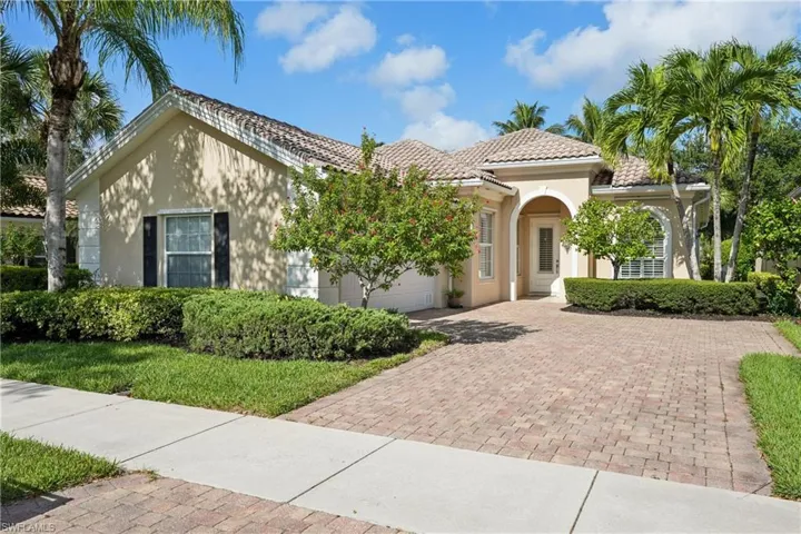 Mediterranean / spanish home with stucco siding, decorative driveway, a tile roof, and an attached garage