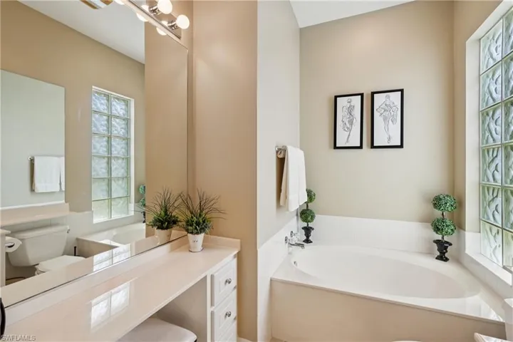 Bathroom featuring a bath and vanity