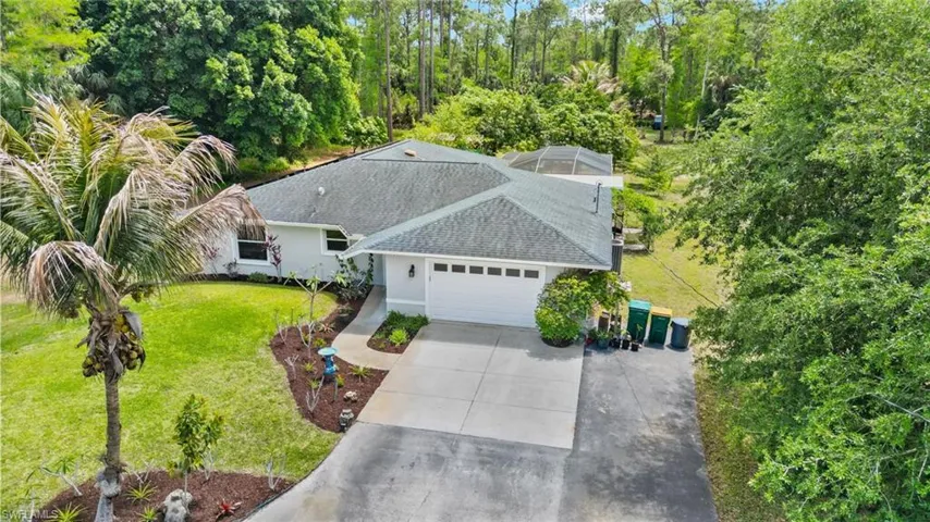 Single-story residence featuring a two-car garage, concrete driveway, and a shingle roof