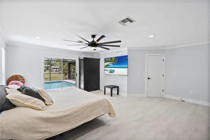 Spacious room featuring light-toned tile flooring, recessed lighting, and crown molding