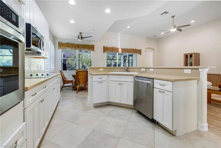 Generous kitchen with corian countertops and stainless appliances