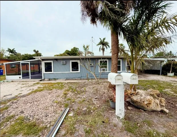 Single story home featuring a sunroom