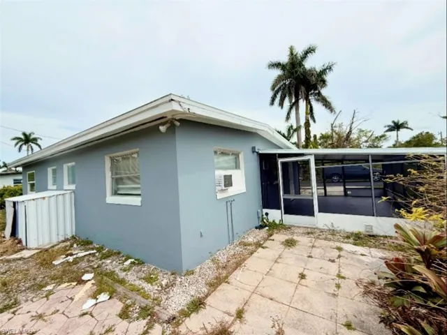 View of property exterior with a sunroom, stucco siding, and a patio area