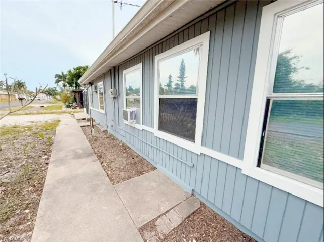 View of side of property featuring cooling unit