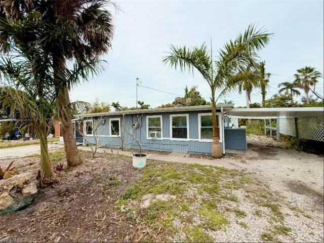 Ranch-style house with an attached carport and driveway