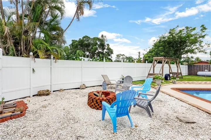 View of yard with a fenced in pool, a patio, and a fire pit