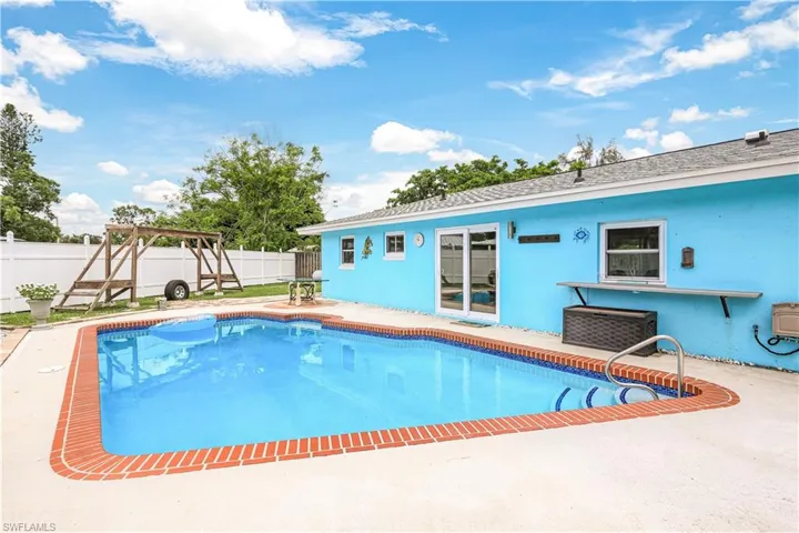 View of swimming pool with a patio area