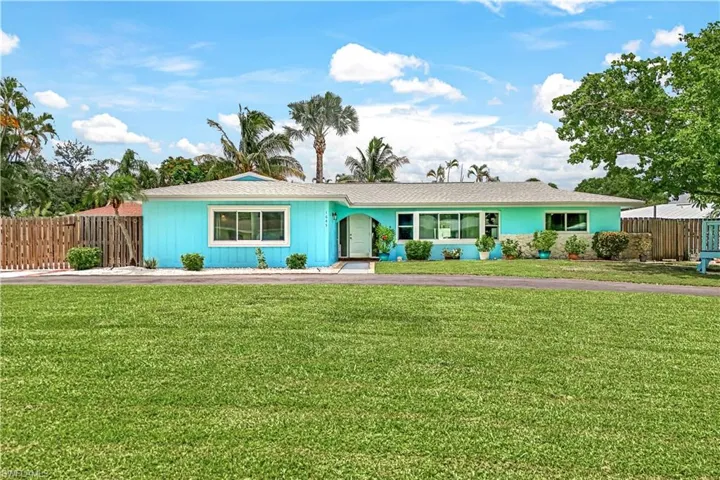 Single story home featuring a front lawn