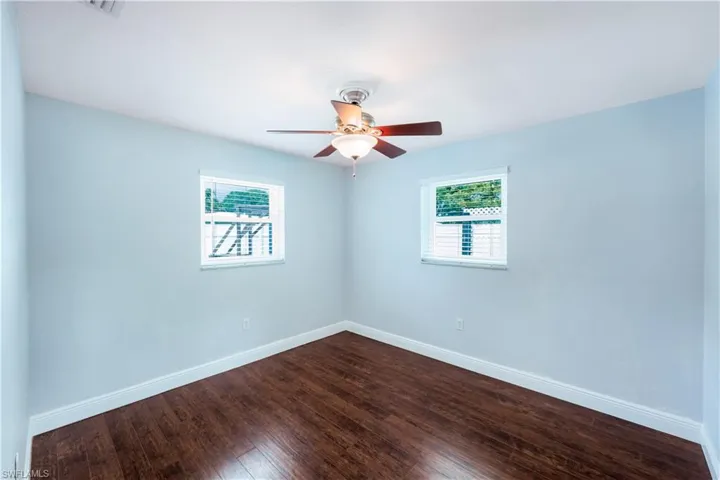 Spare room featuring ceiling fan and hardwood / wood-style floors