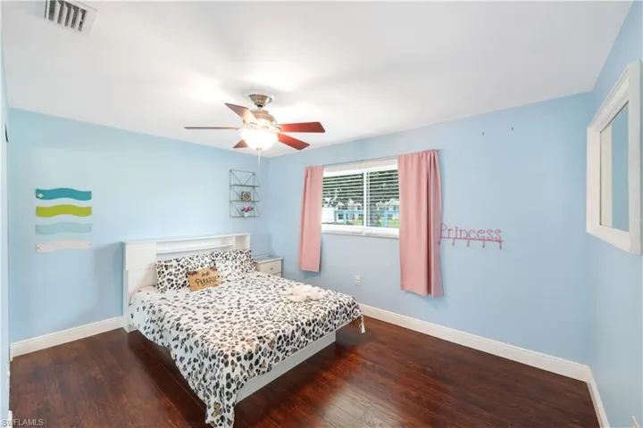 Bedroom featuring ceiling fan and wood-type flooring