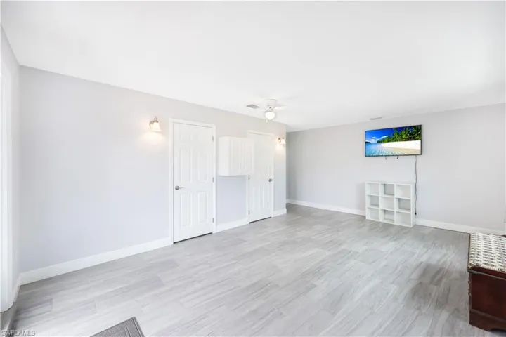 Unfurnished living room with ceiling fan