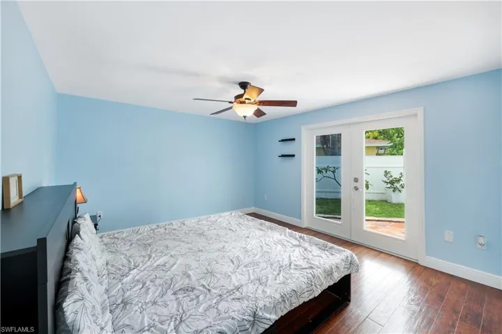Bedroom with access to outside, french doors, hardwood / wood-style floors, and ceiling fan
