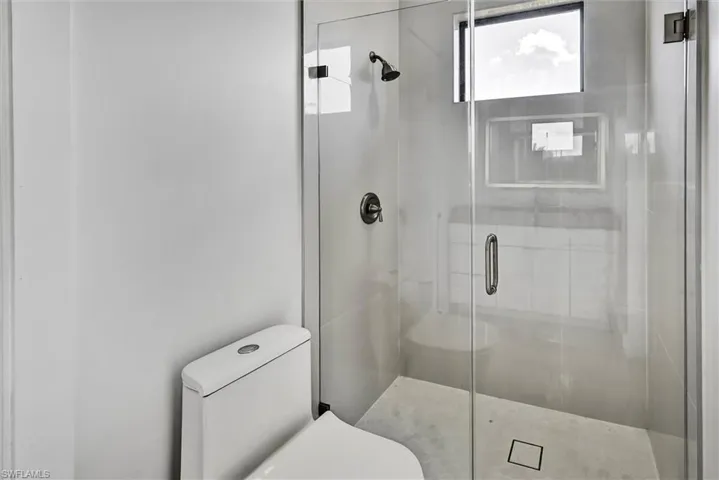 Modern bathroom featuring a frameless glass shower enclosure%