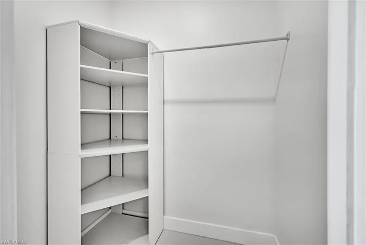 Built-in corner shelving with adjustable shelves and hanging rod