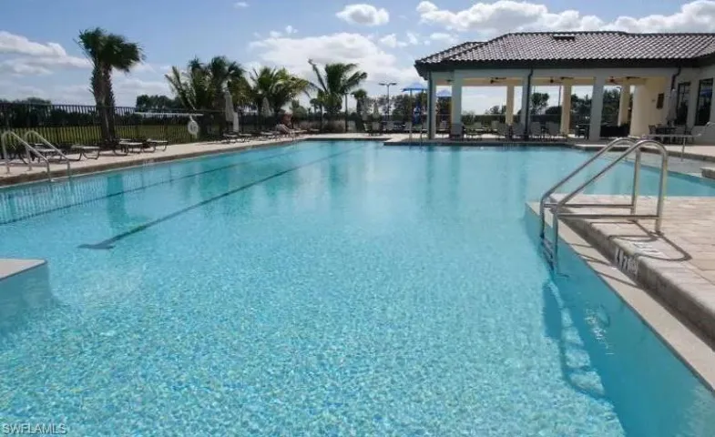 Community pool with a patio