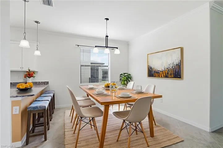 Dining space featuring crown molding and baseboards